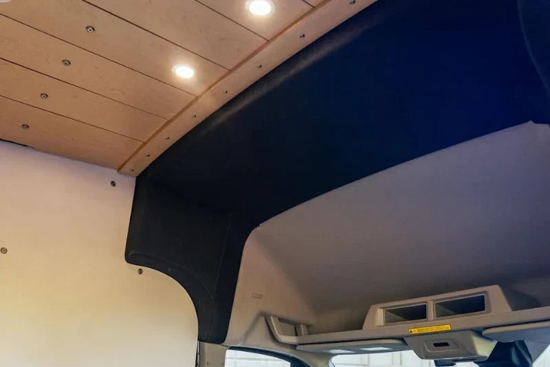 Ford Transit High Roof front trim installed, bulkhead transition close-up - black